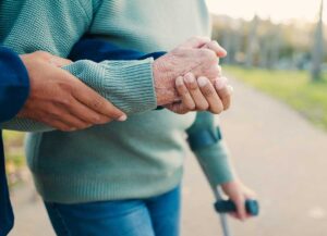 Family members review assisted living information with an older adult at a dining table.